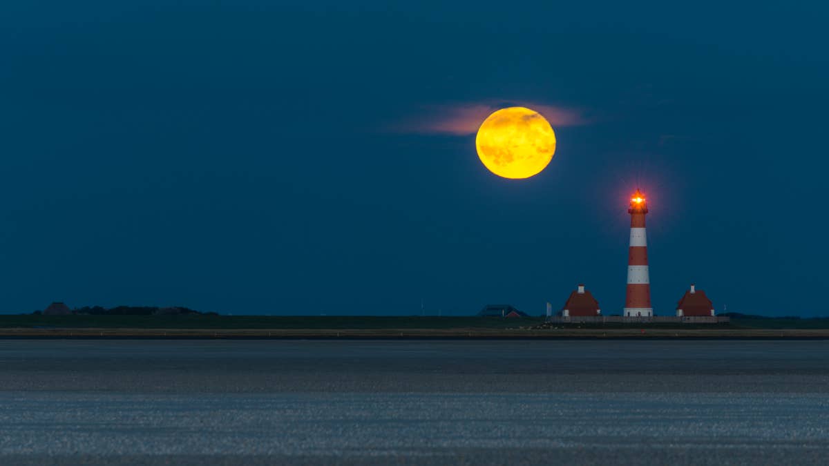 Germany schleswig holstein north sea coast view of westerheversand lighthouse full moon at night